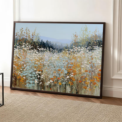 a large, framed painting of a field of flowers, with a variety of colors including white, orange, and green.
