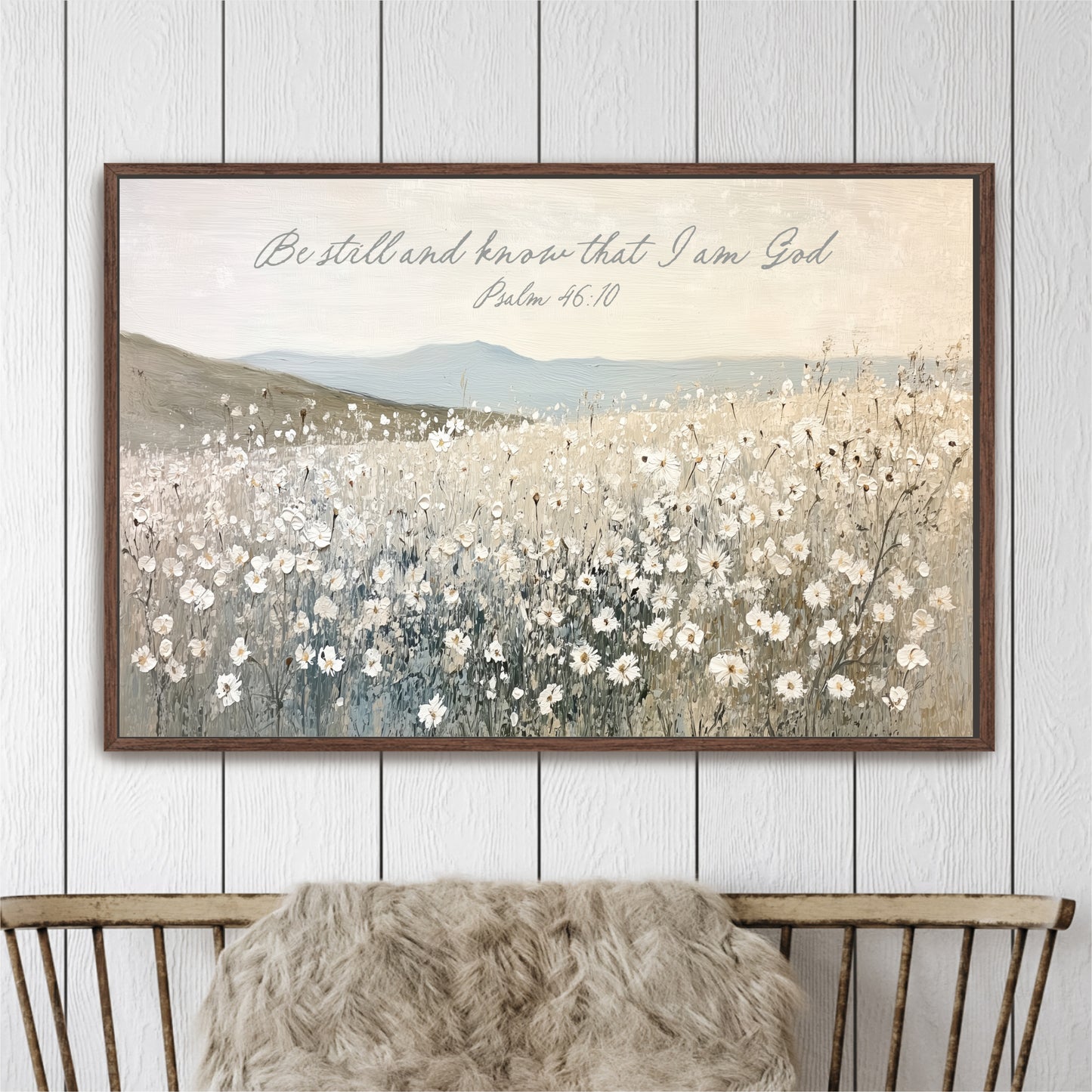 The image is a framed painting depicting a field of white flowers against a backdrop of mountains.