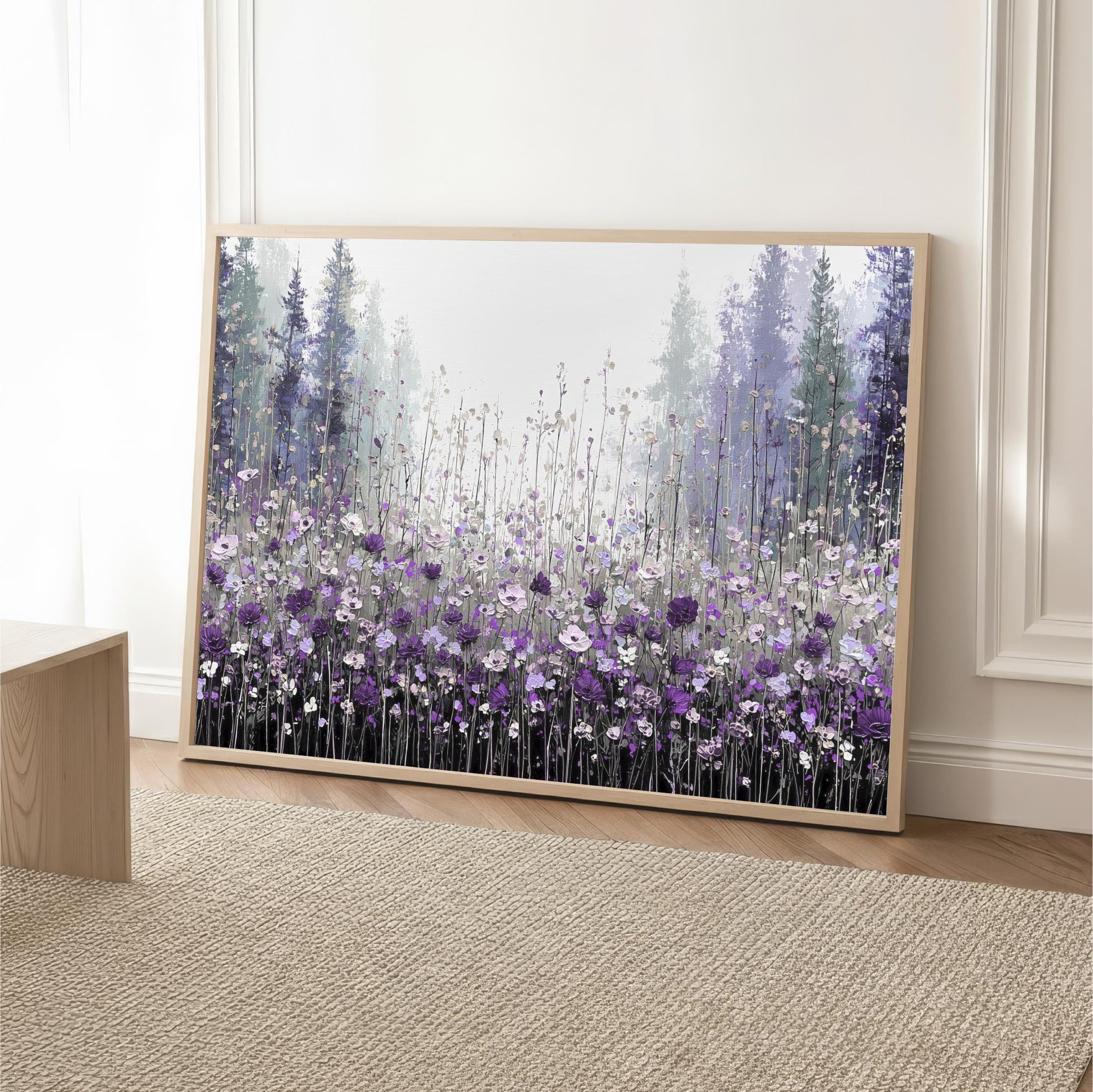 a large framed painting of a field of purple flowers, with tall trees in the background.