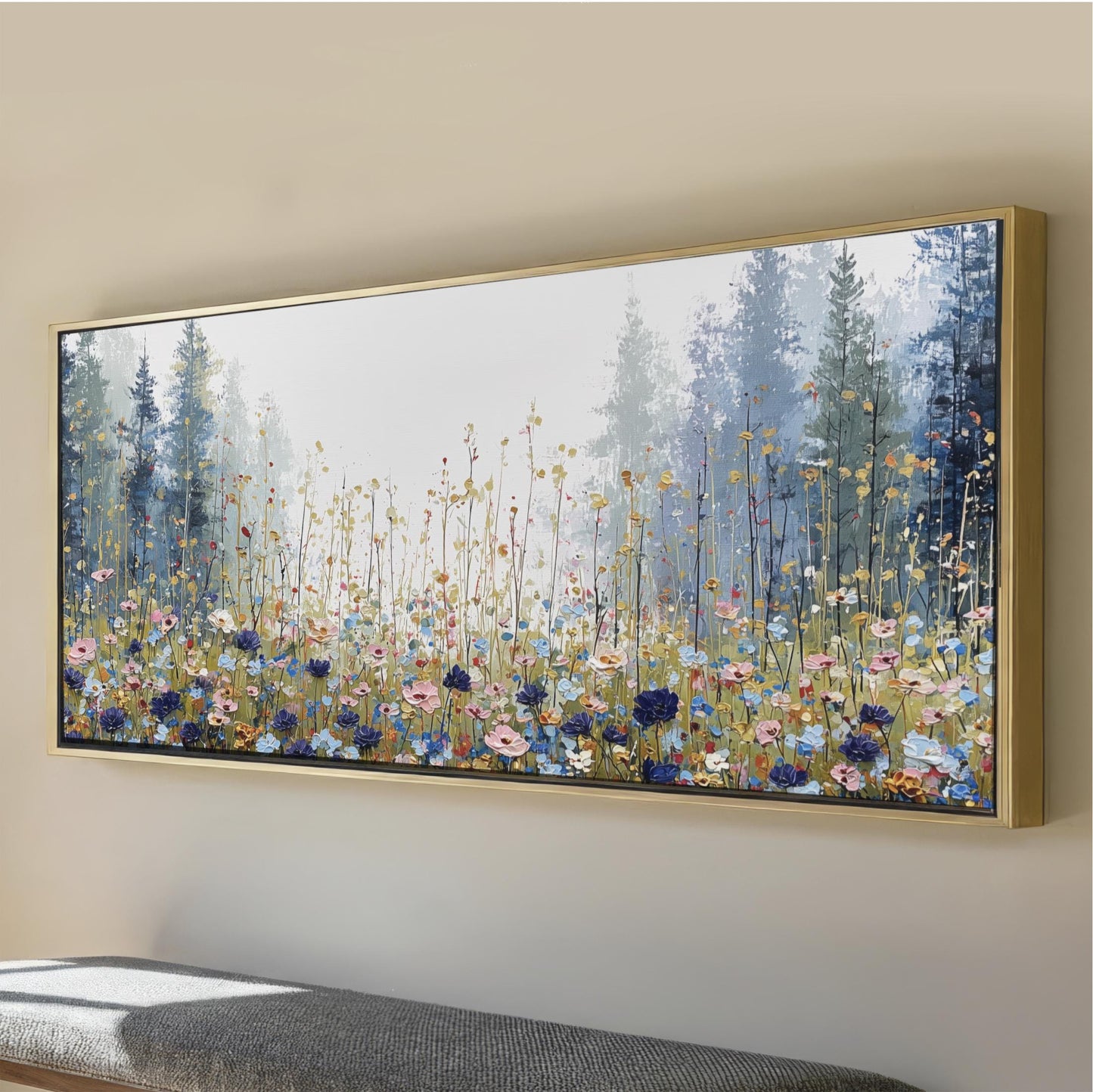 a large, framed painting of a field of flowers, with tall trees in the background.