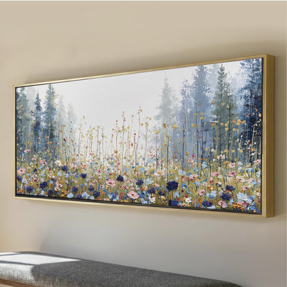 a large, framed painting of a field of flowers, with tall trees in the background.