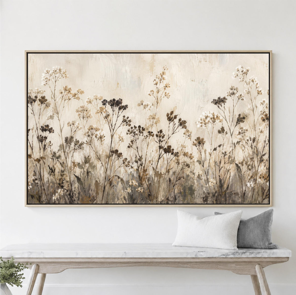 a large painting of a field of flowers hanging on a wall above a wooden bench.