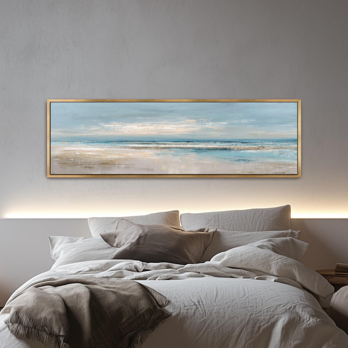 a large, framed painting of a serene beach scene hanging above a bed with white bedding and pillows.