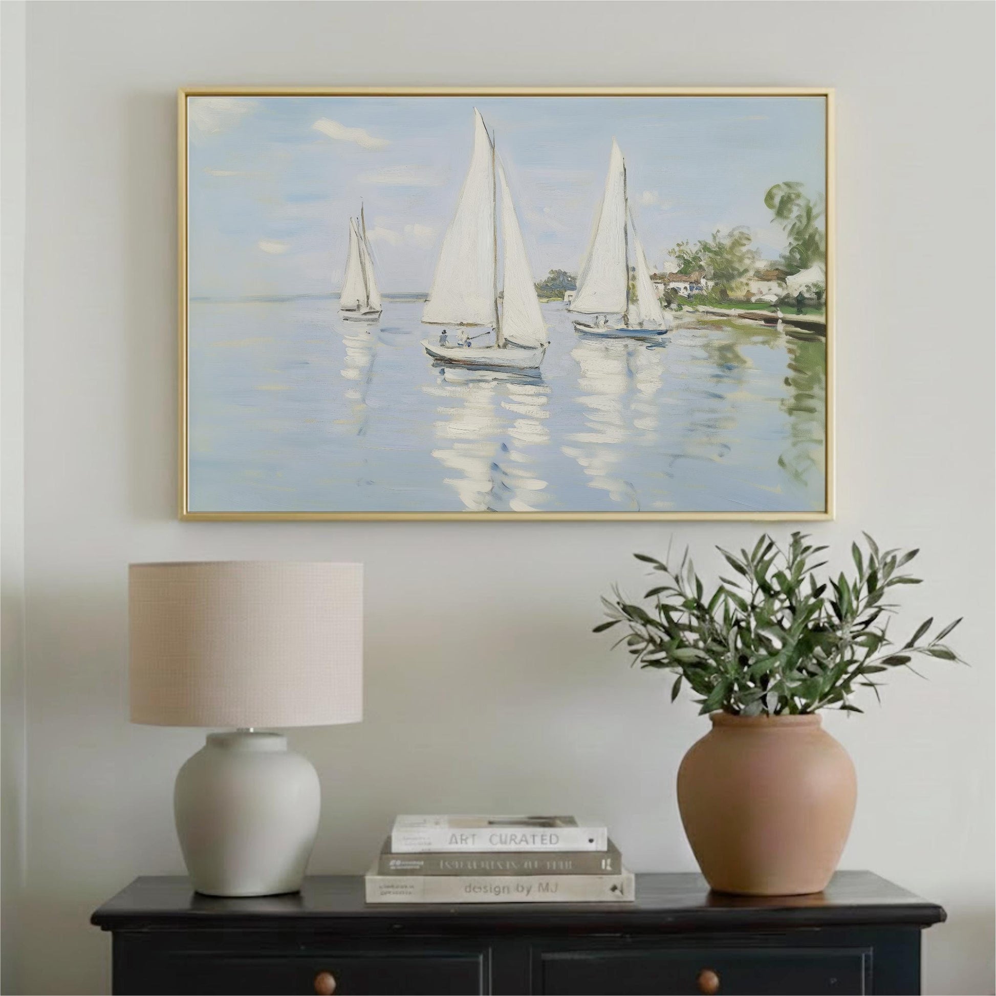 a painting of three sailboats on a calm body of water, hanging on a wall above a black dresser with a lamp and a vase of greenery.