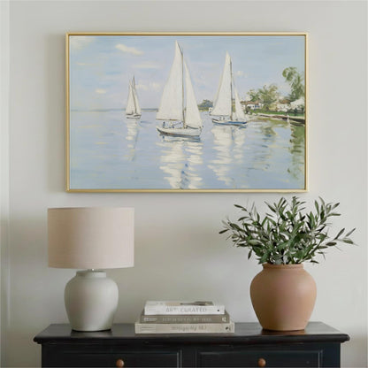 a painting of three sailboats on a calm body of water, hanging on a wall above a black dresser with a lamp and a vase of greenery.