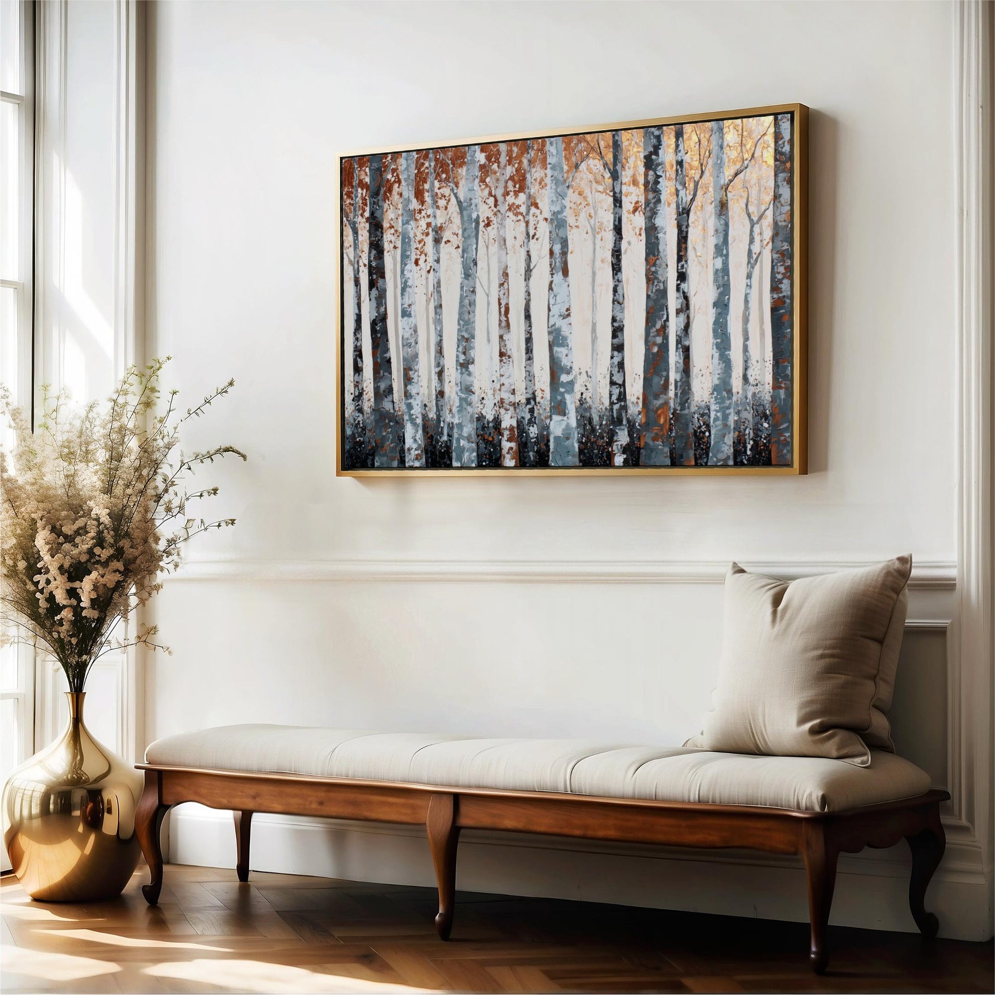a wooden bench with a beige cushion, positioned in front of a large painting of trees on a white wall.