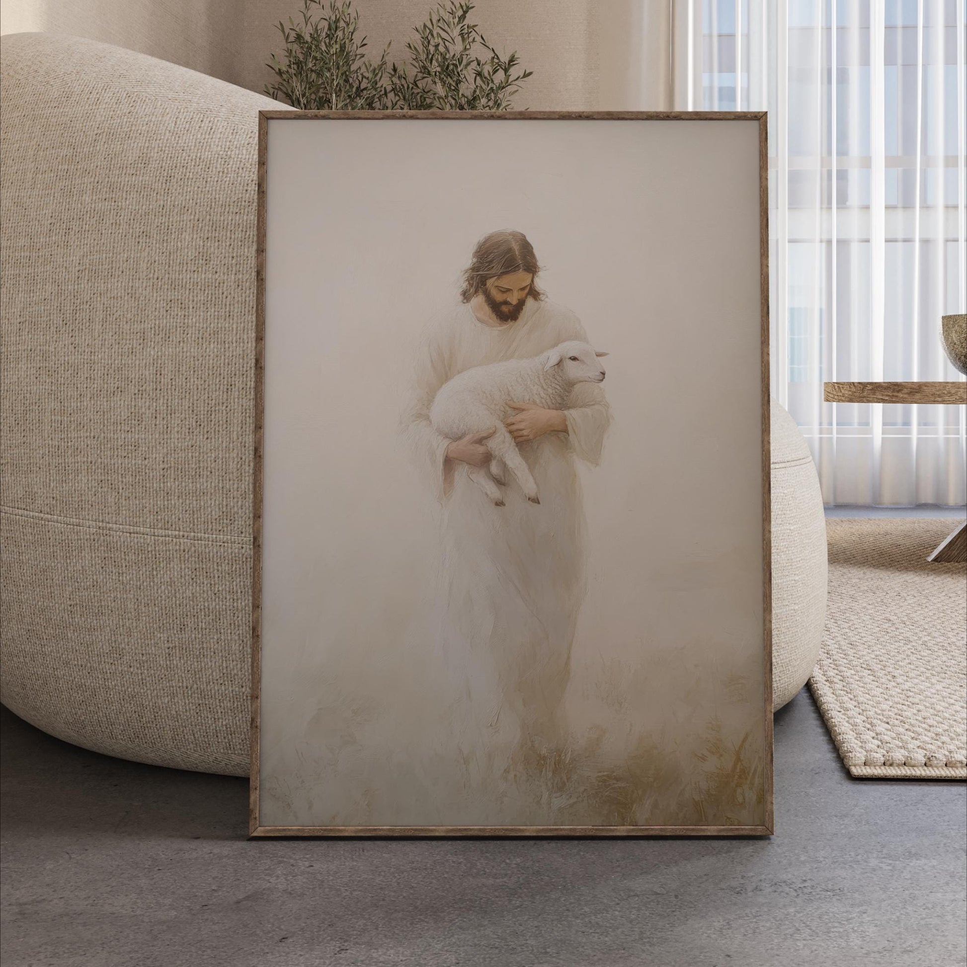 A framed print of a person in a white robe holding a lamb is displayed on a wooden floor in a living room.