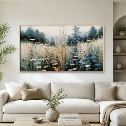 a large, framed painting of a field of flowers hanging on a wall above a white sofa in a living room.