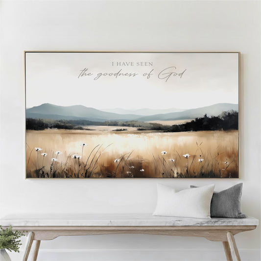 a large framed painting of a field with flowers hanging on a wall above a wooden bench.