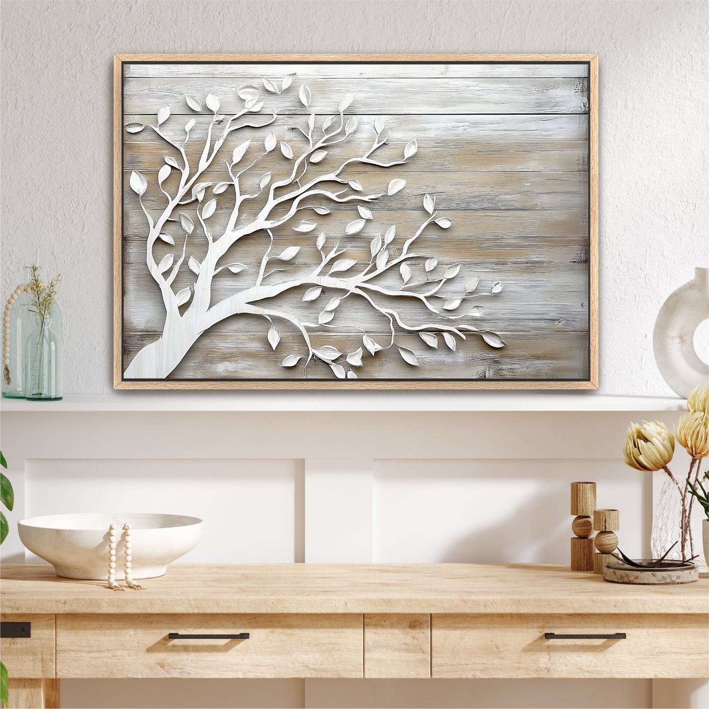 a wooden shelf with a framed picture of a tree on it, along with some decorative items such as a vase and a bowl.