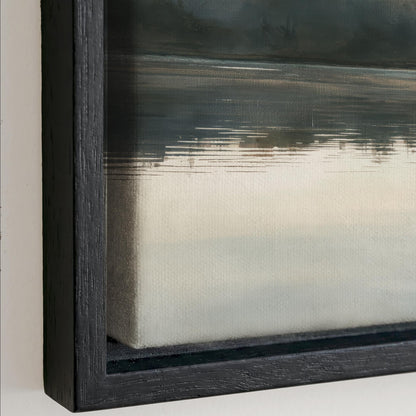 The image is a close-up of a framed painting depicting a landscape scene with a body of water and a cloudy sky.