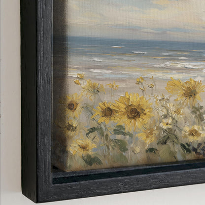 The image is a framed painting depicting a serene beach scene with a field of yellow sunflowers in the foreground and the ocean in the background.