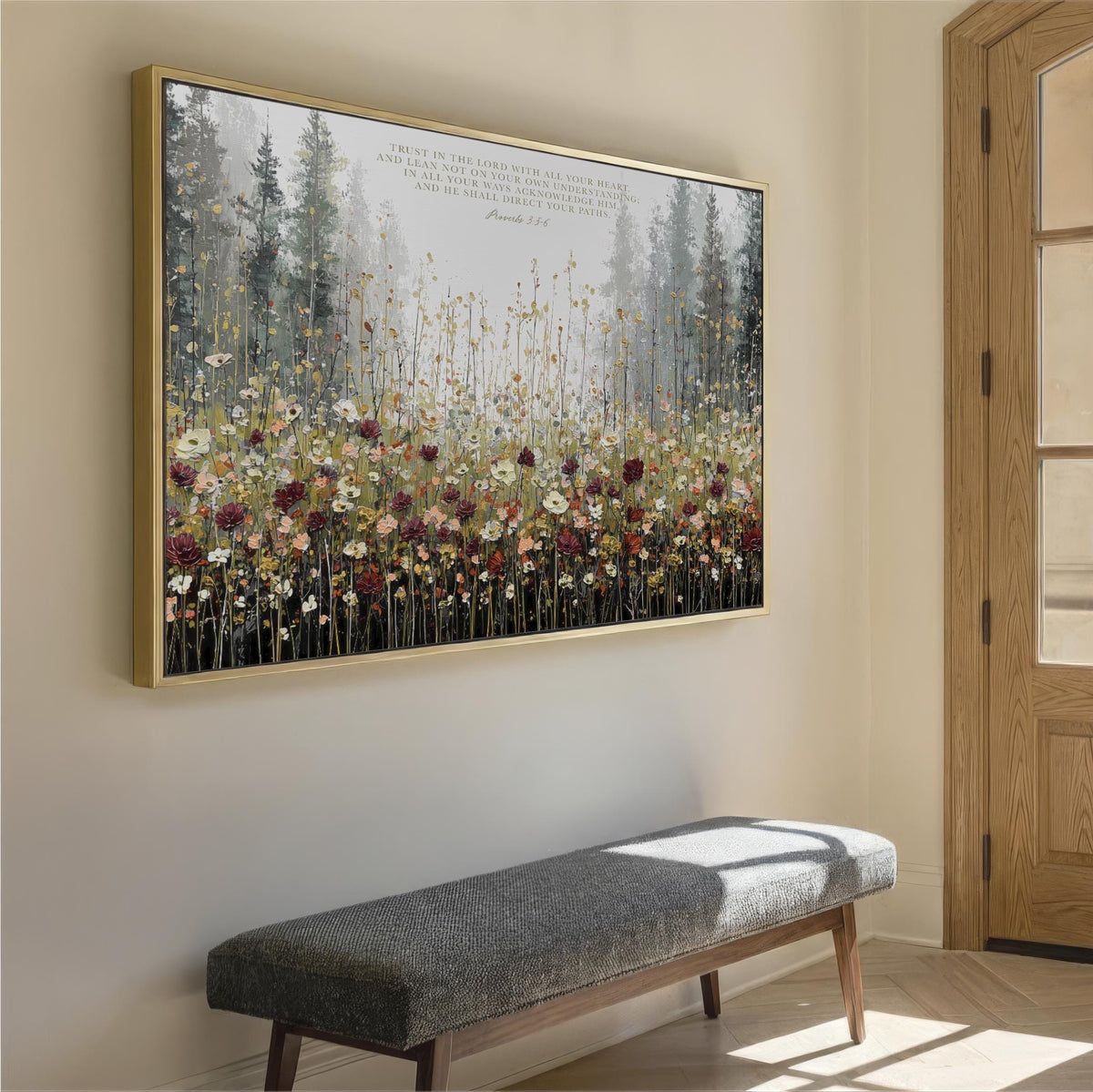 a large framed painting of a field of flowers hanging on a wall, with a bench placed in front of it.