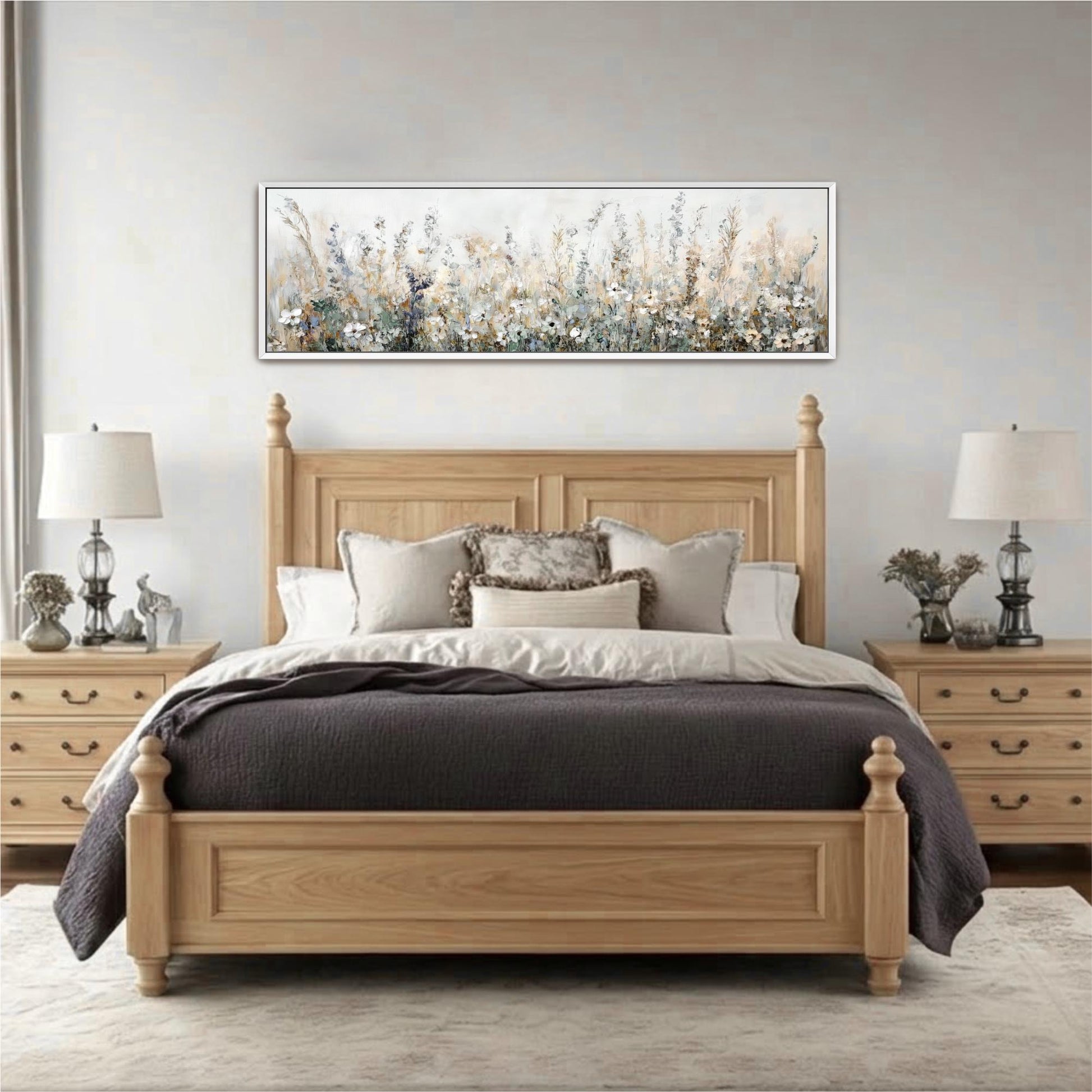 a serene and cozy bedroom with a large wooden bed, a wooden headboard, and a large painting of a field of flowers hanging above it. The bed is adorned with a gray comforter and a gray throw blanket, and the room features a gray rug and two lamps on either side of the bed.