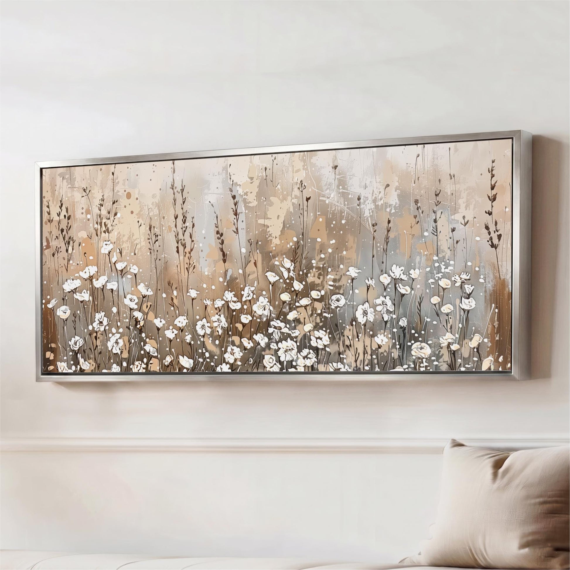 a large framed painting of a field of white flowers hanging on a wall.