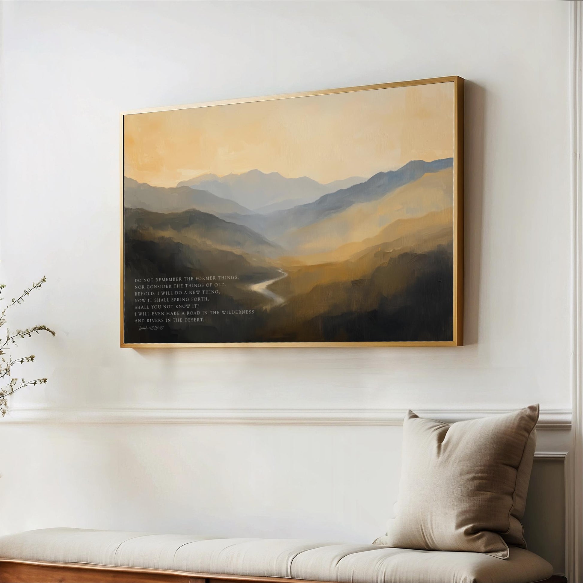 a large landscape painting hanging on a white wall, with a wooden bench and a beige pillow in the foreground.