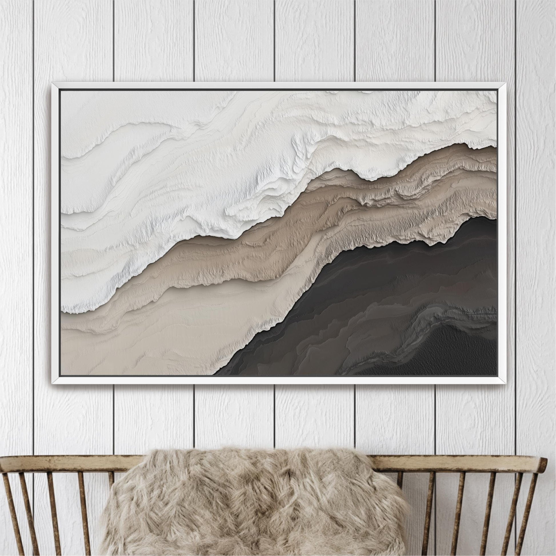 a large abstract painting hanging on a white wall above a wooden chair.
