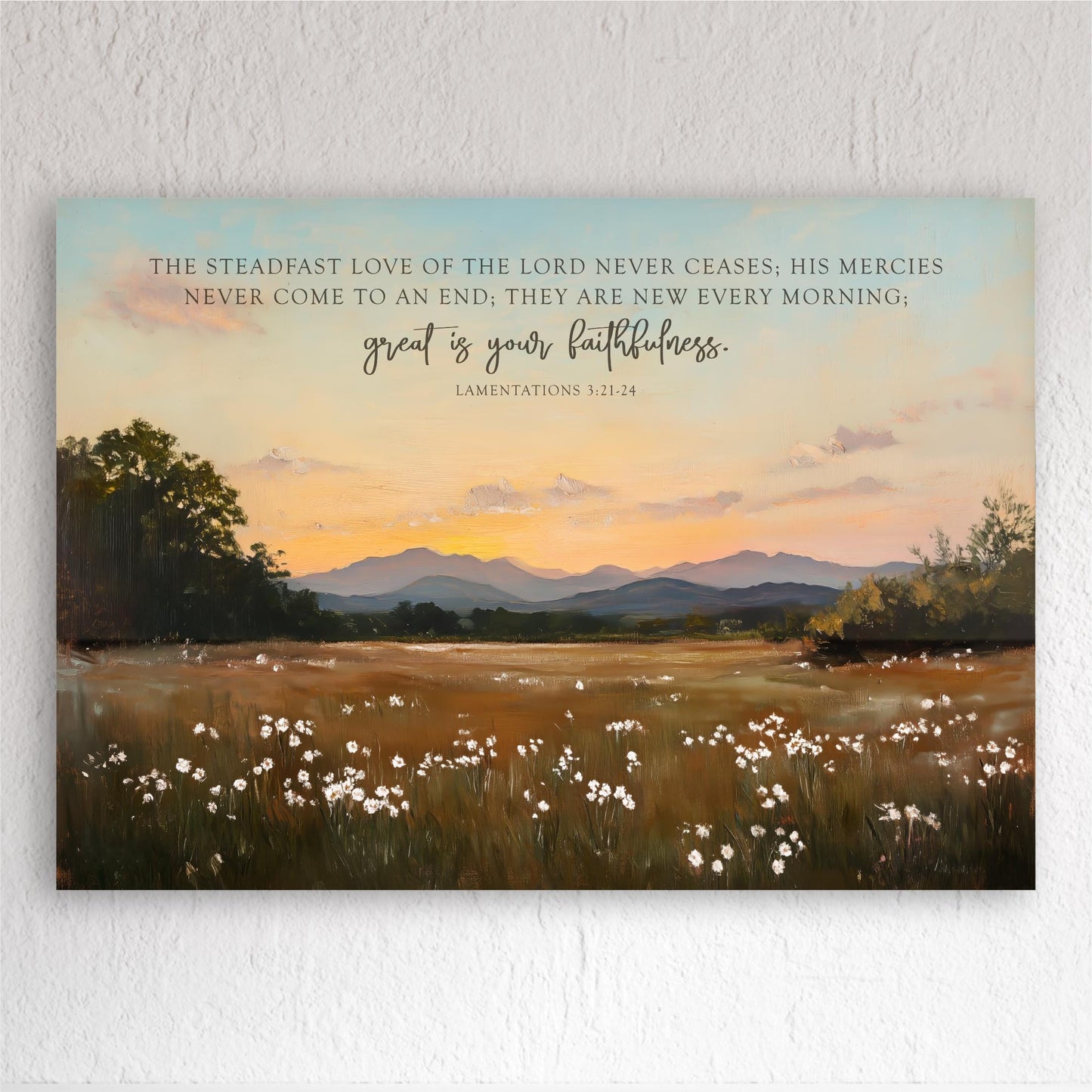 a serene landscape with a field of white flowers, mountains in the distance, and a sunset sky. The text overlay provides a biblical quote from the book of Laminated Scriptures, which reads "The steady love of the Lord never ceases, His mercies never come to an end, they are new every morning, great is your faithfulness."