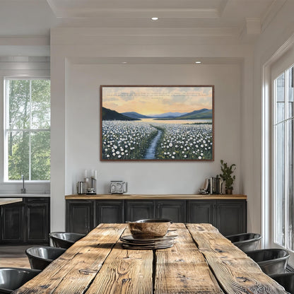a large painting of a field of flowers hanging on the wall above a wooden dining table with black chairs.