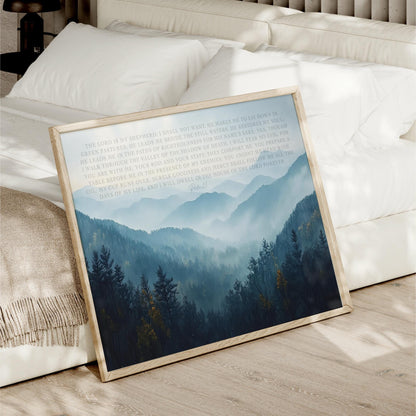 a framed print of a serene mountain landscape with pine trees and a misty, hazy atmosphere.