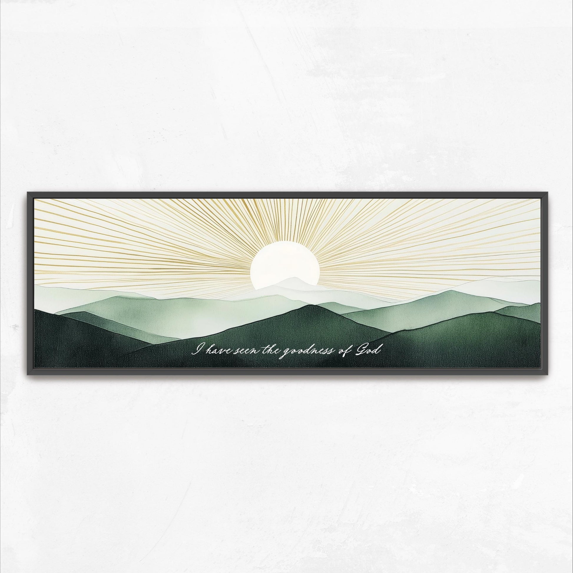 A framed artwork depicting a serene landscape with mountains and a sun rising over the horizon.