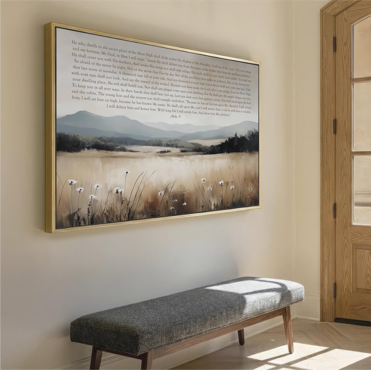 a large framed painting of a serene landscape with a field of tall grass and a body of water in the background, hanging on a wall above a gray bench.