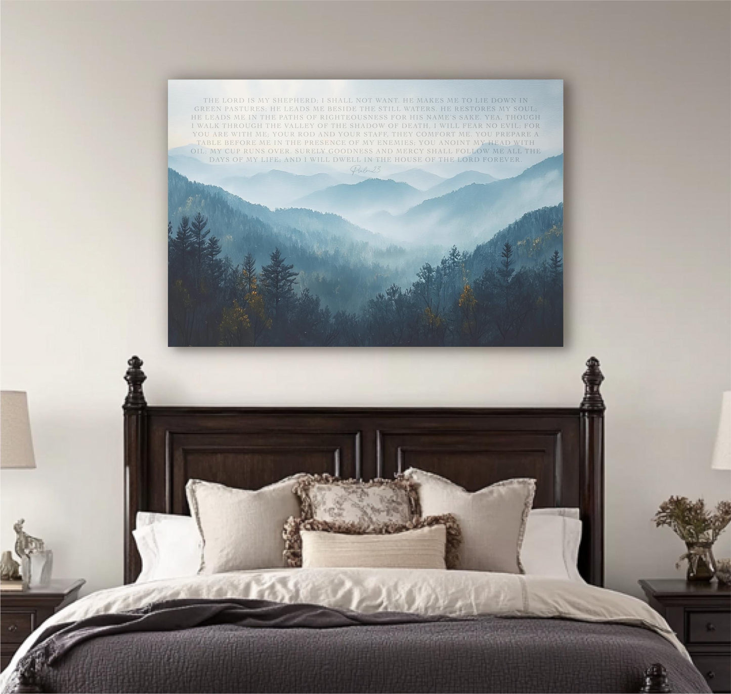 a large bedroom with a wooden headboard and a bed with white bedding. Above the bed, there is a large canvas print depicting a mountain landscape with trees and mountains in the background.