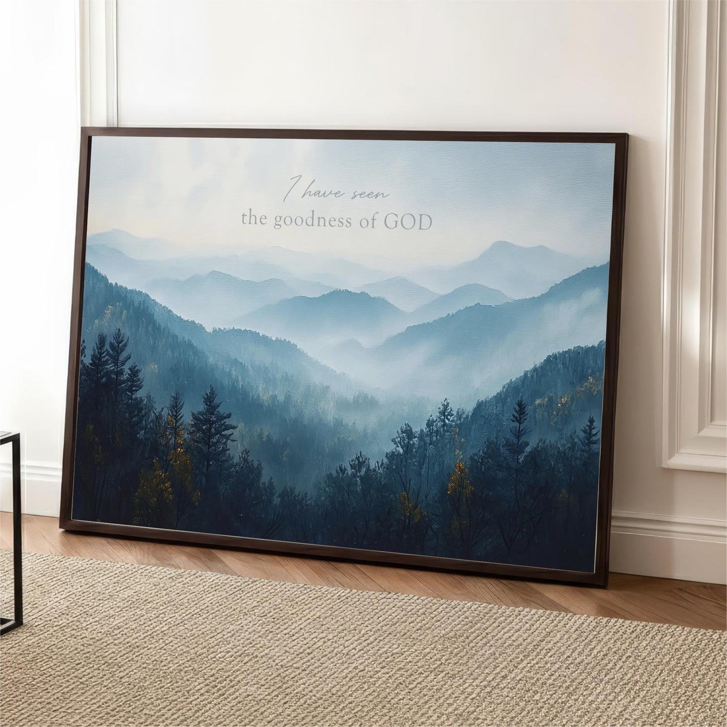 The image is a framed poster depicting a serene mountain landscape with a forested area and misty mountains in the background.