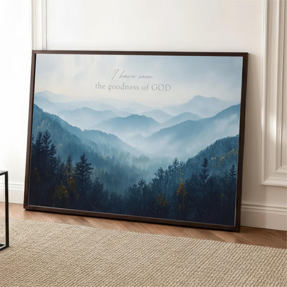 The image is a framed poster depicting a serene mountain landscape with a forested area and misty mountains in the background.