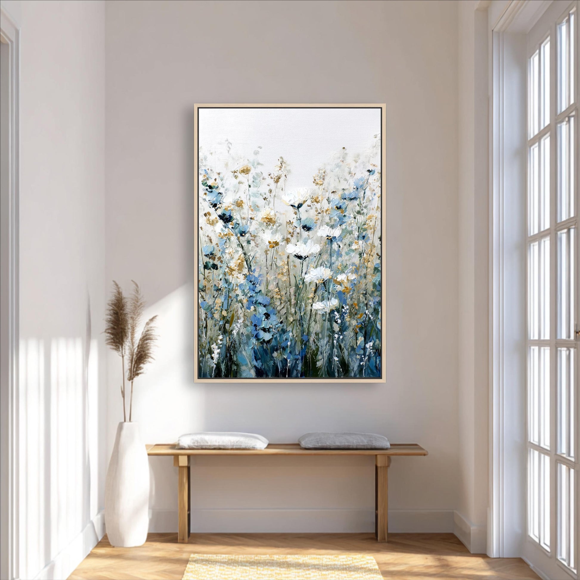 a large painting of flowers hanging on a wall in a room with a wooden bench and a white vase.