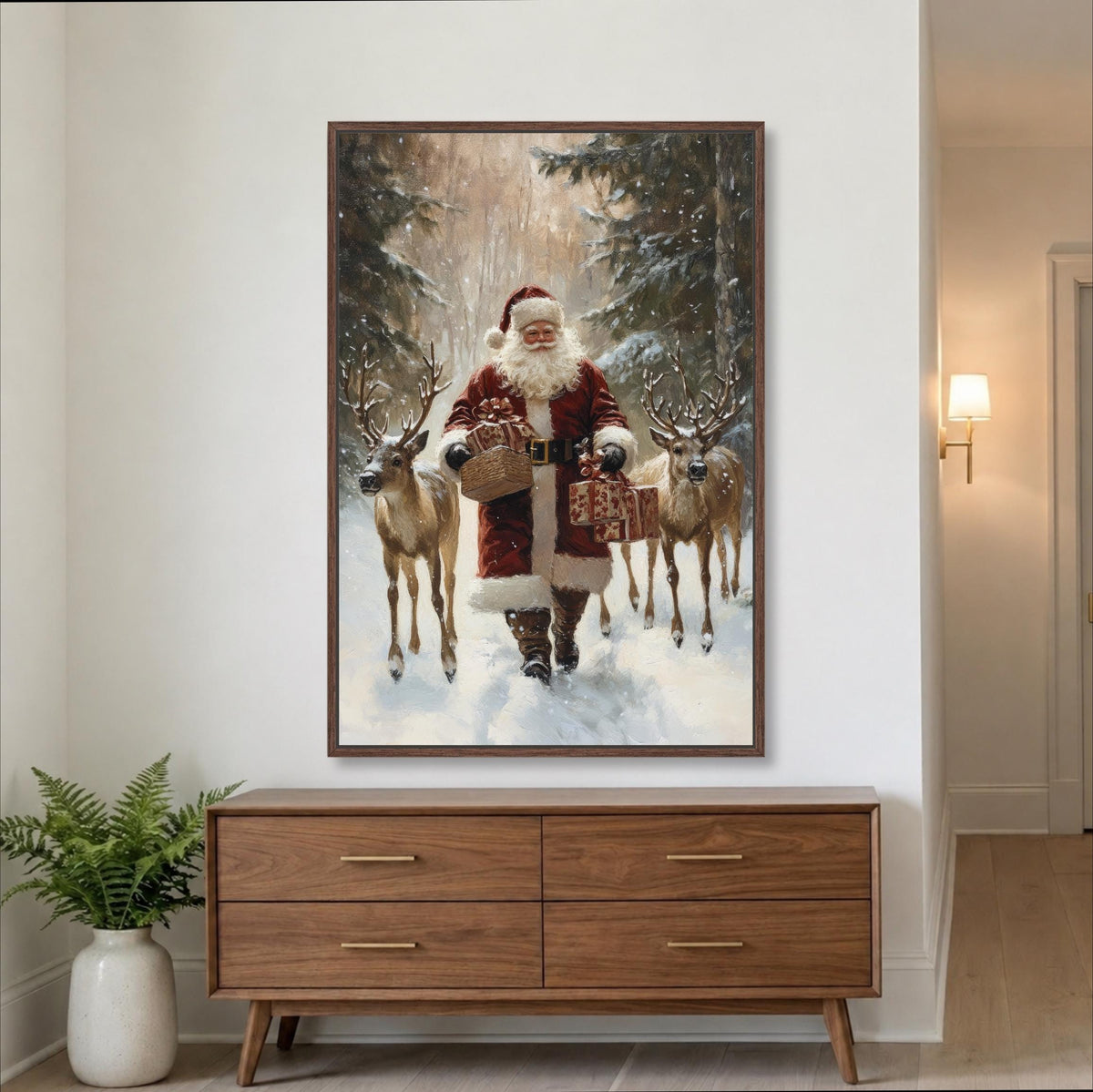 A framed painting of Santa Claus holding reindeer in a snowy forest setting.