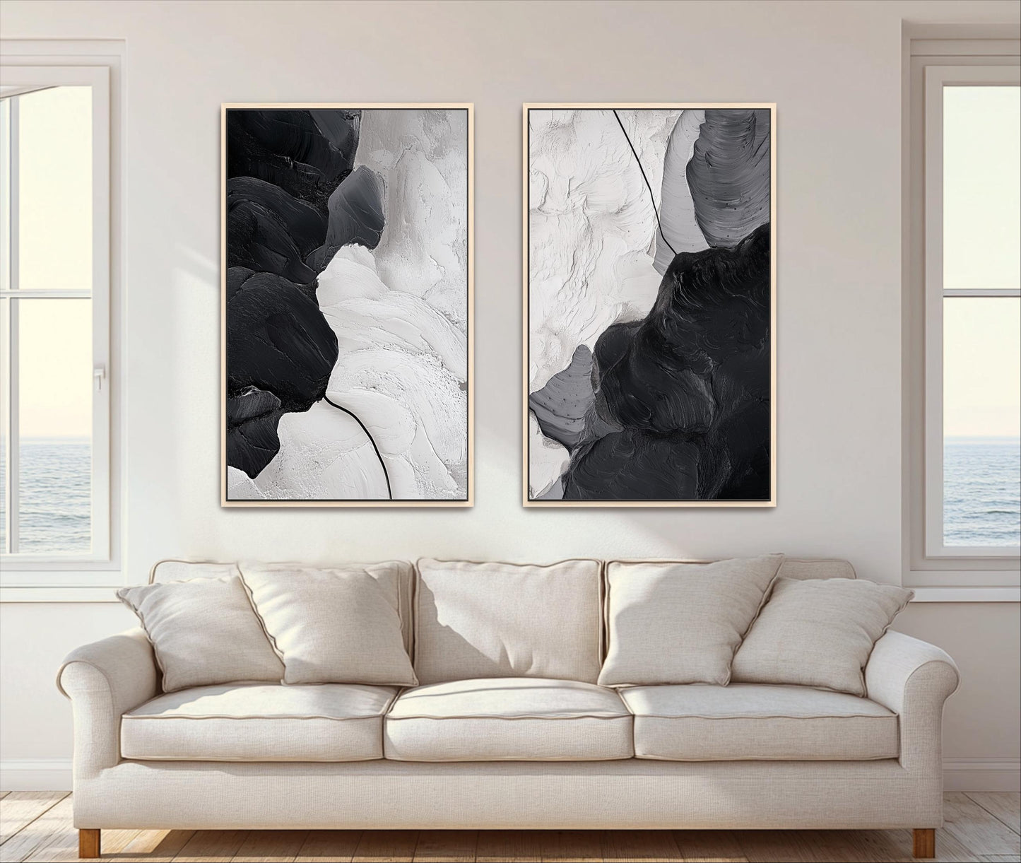two large abstract paintings hanging on a wall above a beige sofa in a living room.