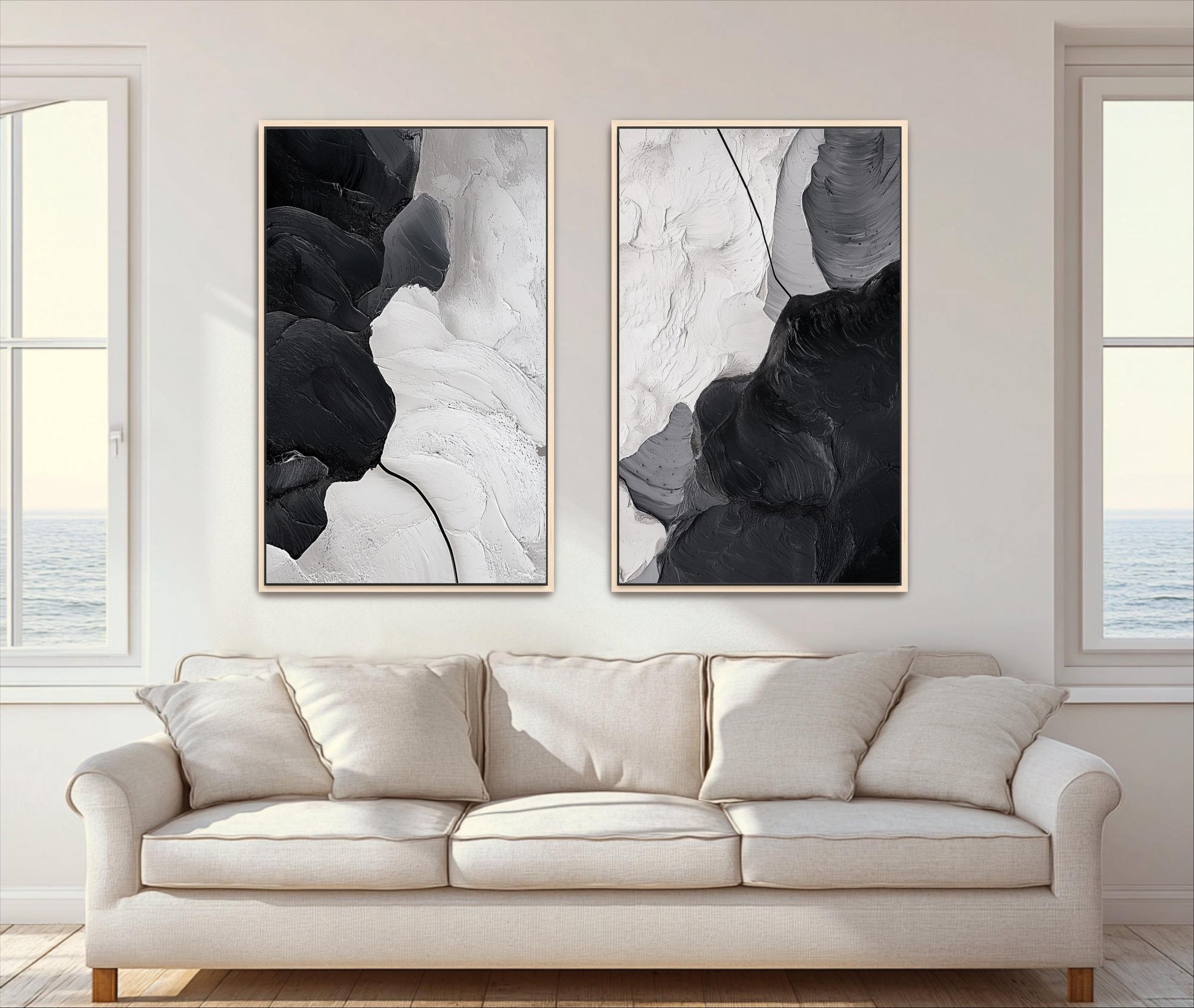 two large abstract paintings hanging on a wall above a beige sofa in a living room.