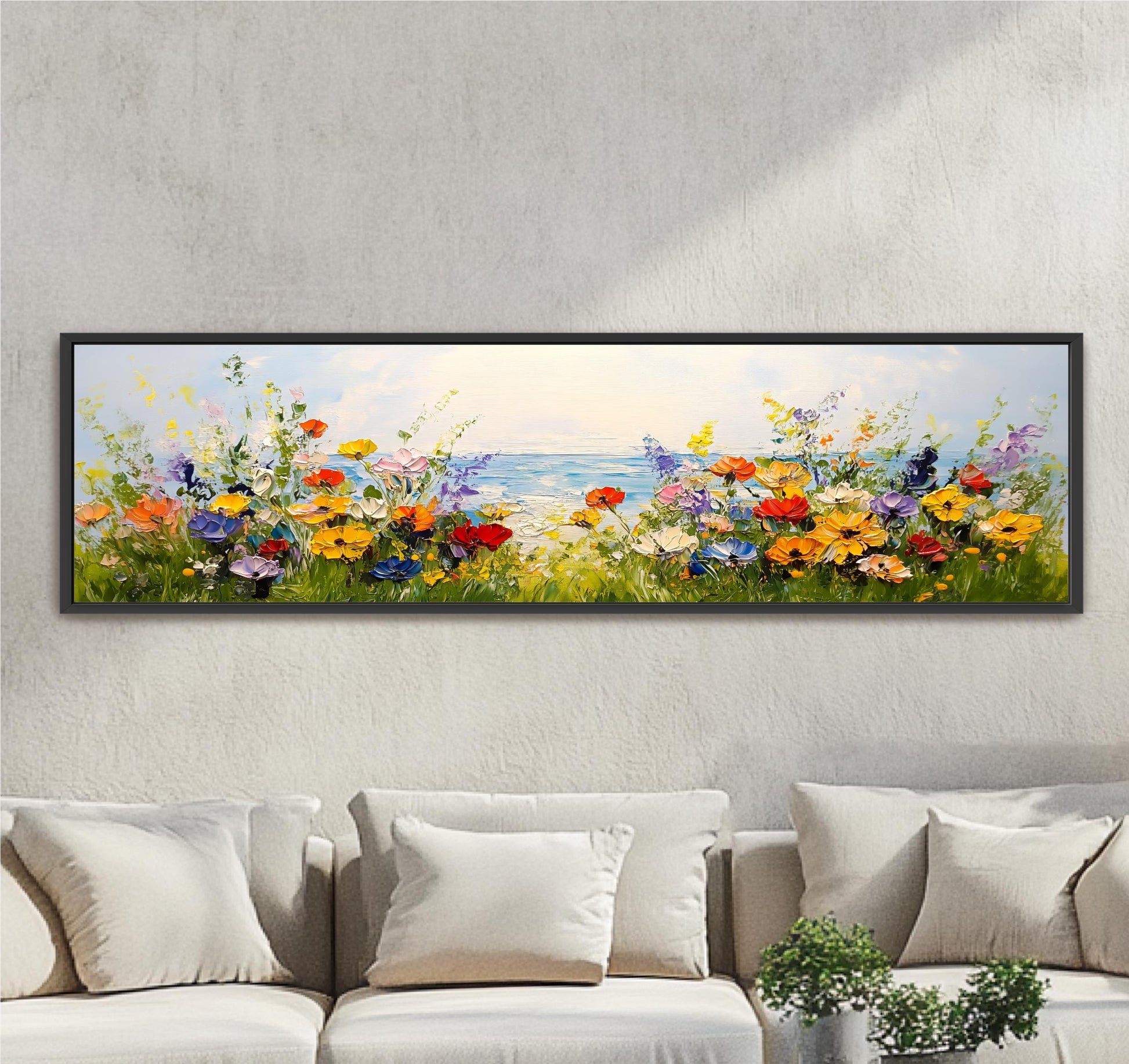 A large, colorful painting of a field of flowers is hanging on a wall above a couch in a living room.