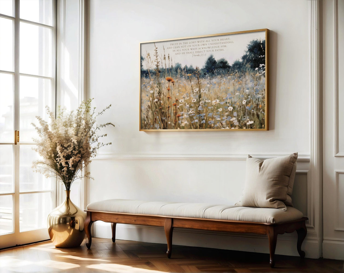 a serene indoor setting with a large painting of a field of flowers hanging on the wall, a wooden bench with a beige cushion, and a vase of white flowers on a side table.