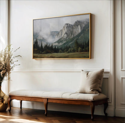 a large landscape painting hanging on a white wall above a wooden bench with a beige cushion.