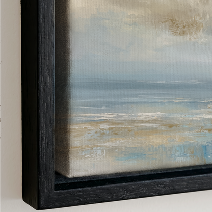 The image is a framed painting depicting a serene landscape with a calm body of water and a cloudy sky.