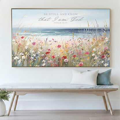 a large framed painting of a field of flowers hanging on a wall above a wooden bench.