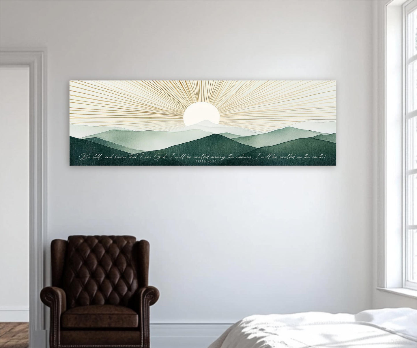 a large, rectangular canvas print depicting a serene landscape with mountains and a sun-like design in the sky. The print is hung on a white wall above a brown leather armchair, creating a cozy and inviting atmosphere in the room.