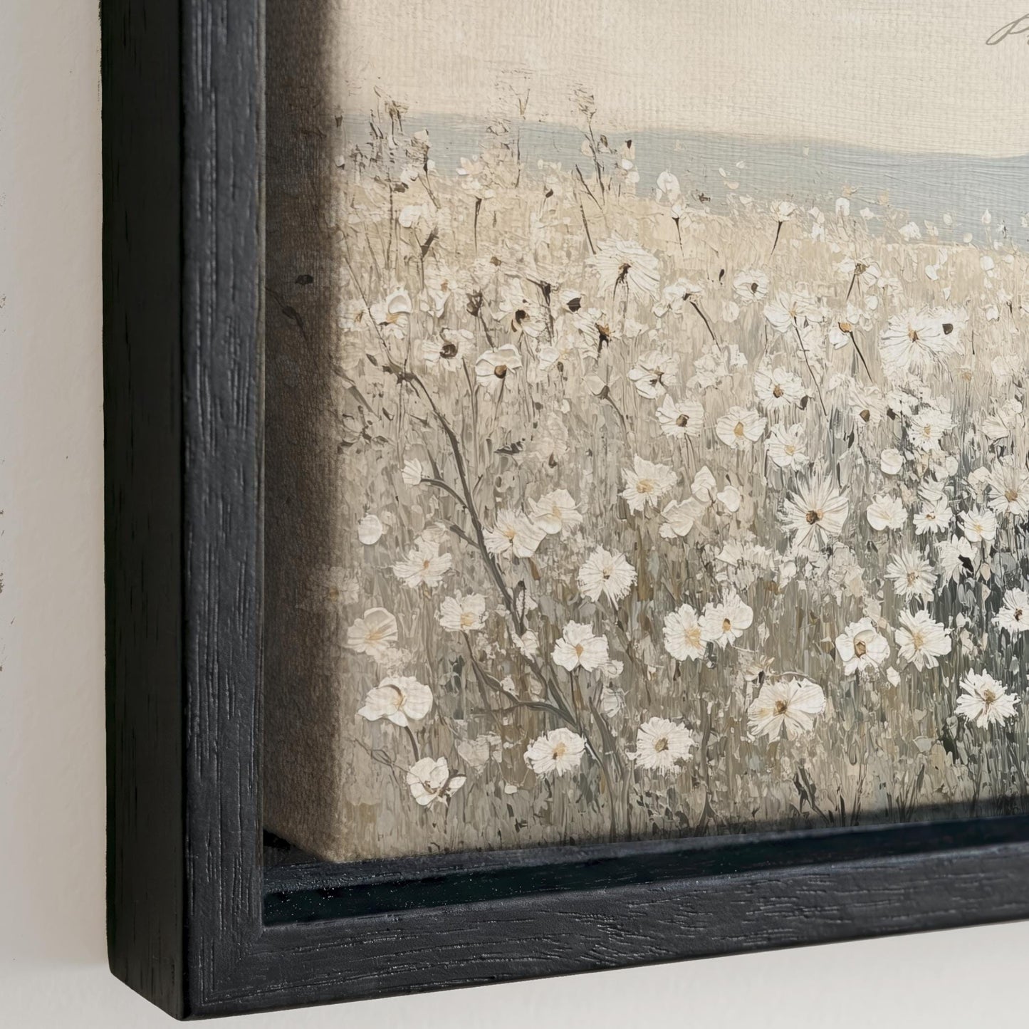 The image is a painting of a field of white flowers, with the flowers appearing to be in various stages of bloom. The painting is framed in a black frame and is displayed on a wall.