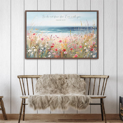a wooden bench with a furry blanket draped over it, set against a white wall with a framed painting of a field of flowers above it.