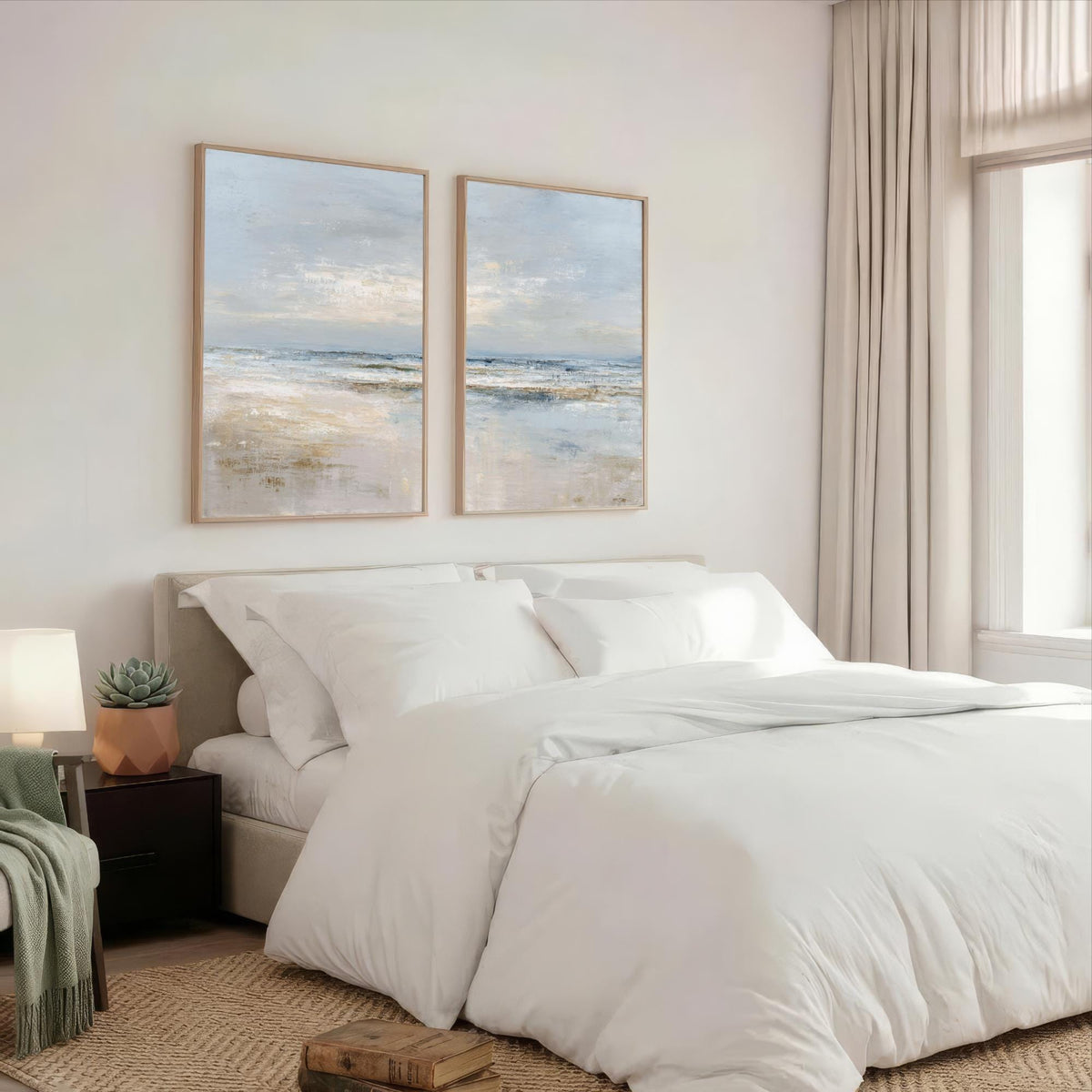 a serene bedroom with a large bed, white bedding, and two framed landscape paintings on the wall above it.