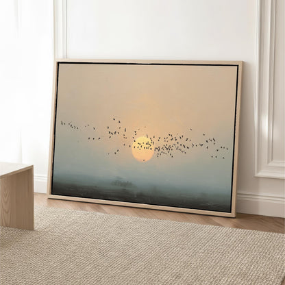 A framed painting depicting a flock of birds flying in the sky against a backdrop of a sunset.