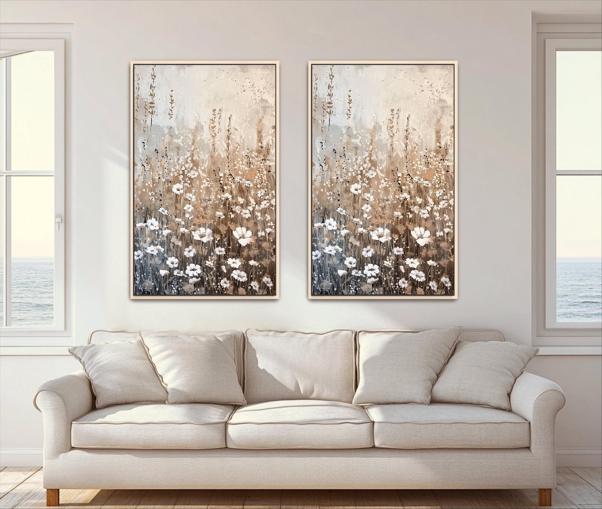 a living room with a white sofa and two framed paintings of flowers hanging on the wall above it.