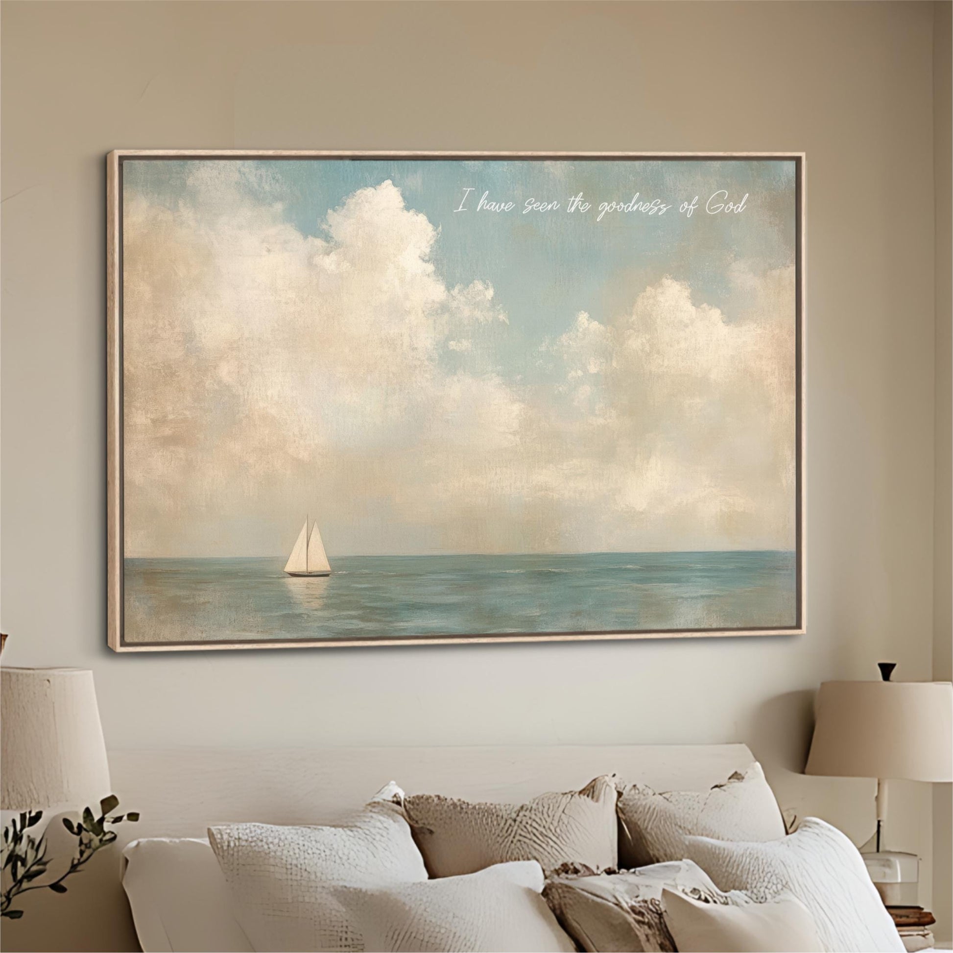 a large painting of a sailboat on the ocean, hanging on a wall above a bed with white pillows.