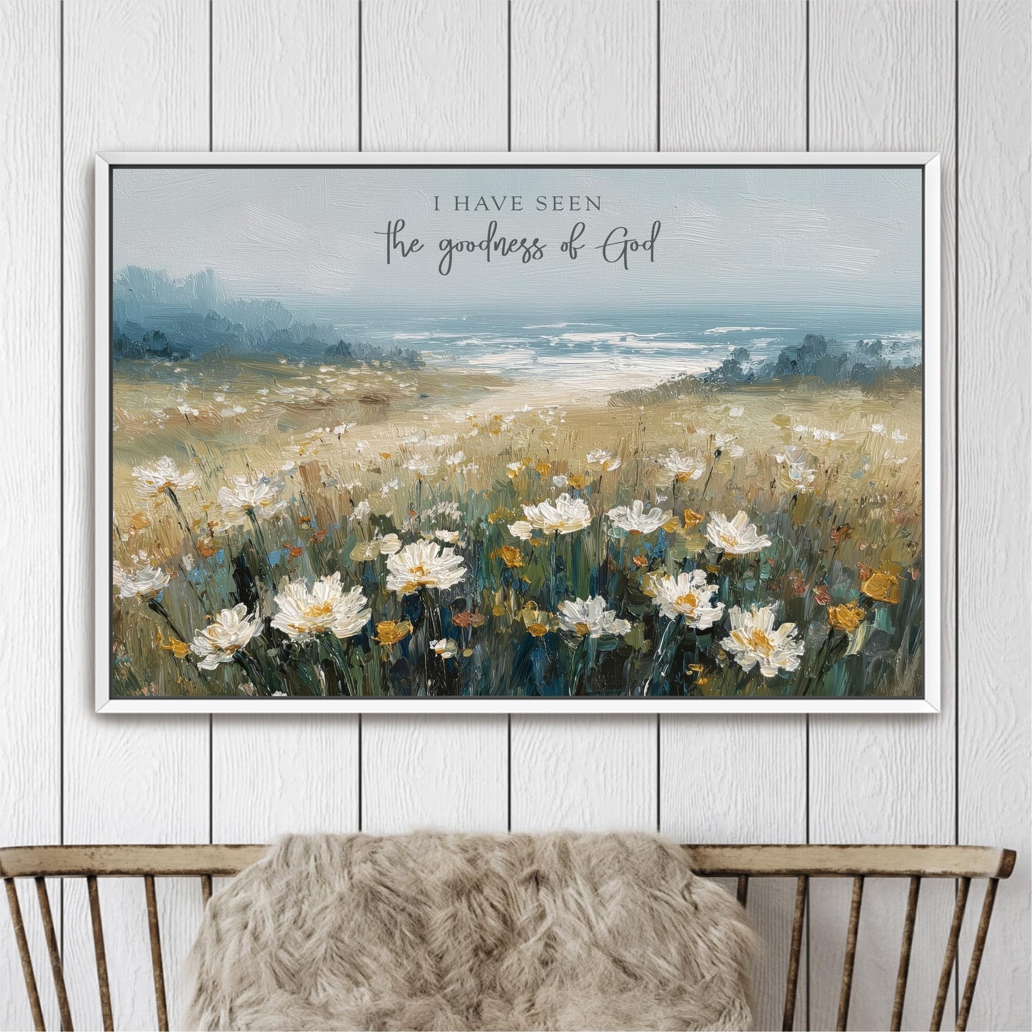 The image is a framed painting depicting a field of white flowers against a backdrop of a blue sky and a body of water.