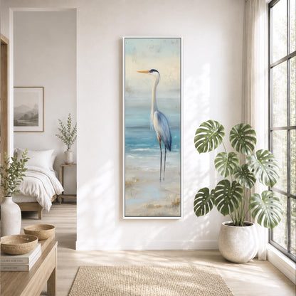 a serene living room with a large painting of a blue heron standing on a beach, surrounded by potted plants and a large window that allows natural light to fill the space.