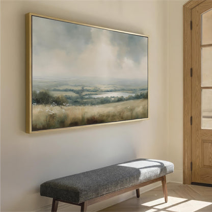 a large landscape painting hanging on a wall, with a wooden bench placed in front of it.