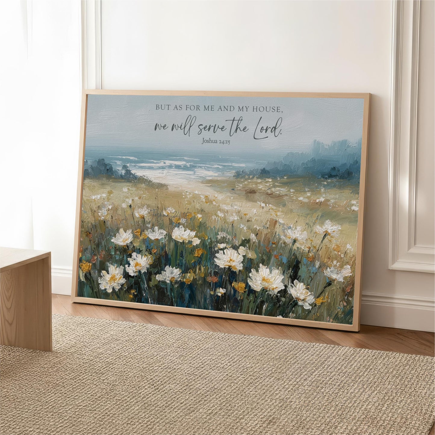 A framed painting depicting a field of white flowers against a blue sky, with a text overlay that reads "But as for me and my house, we will serve the Lord."
