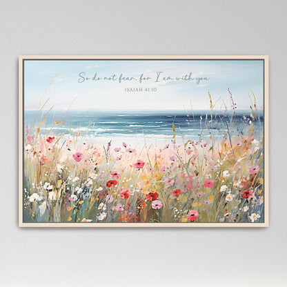 The image is a framed painting depicting a vibrant field of colorful flowers with a serene ocean view in the background.
